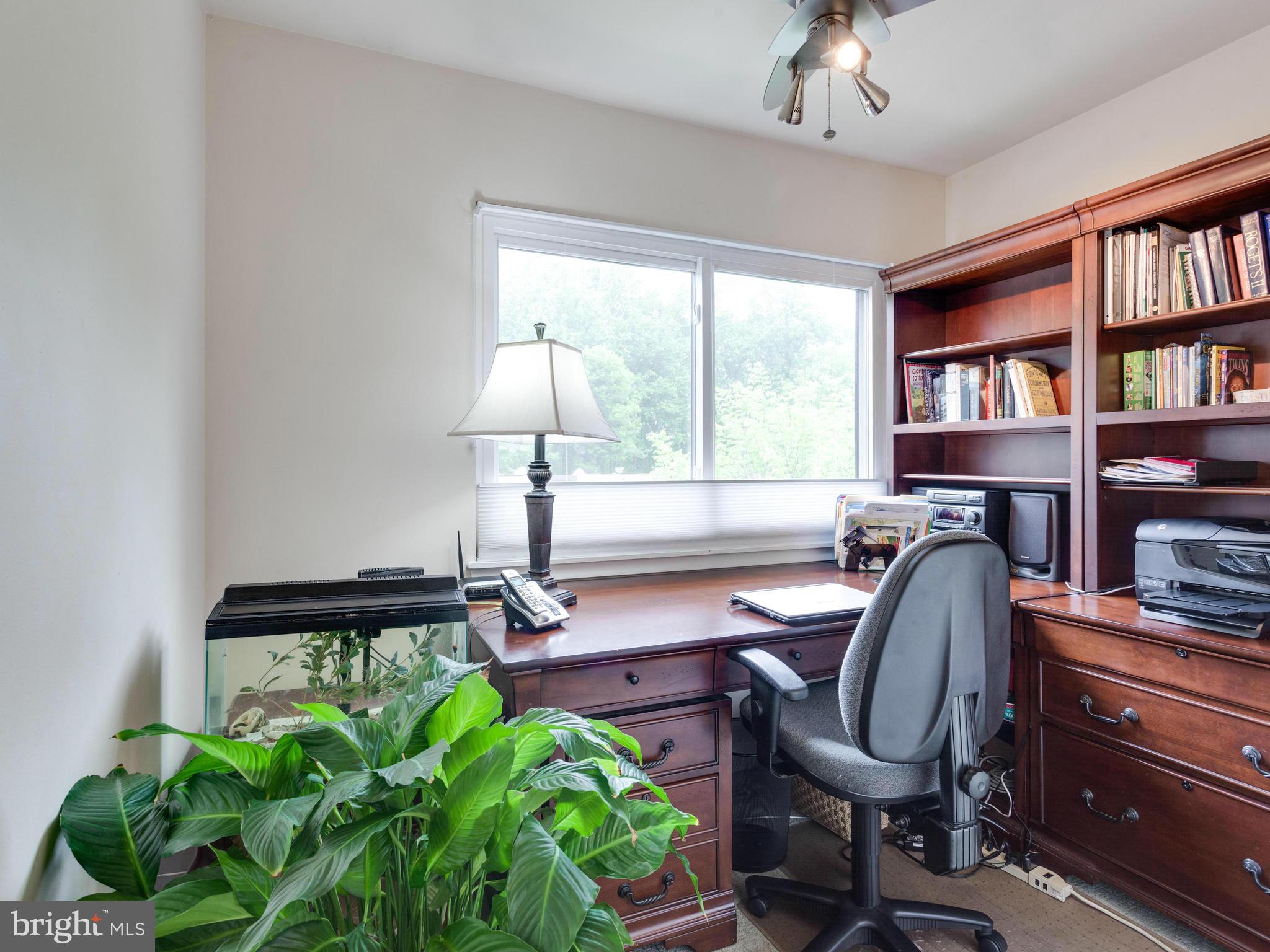2357 Glade Bank Way Reston, VA 20191 - Photo 23 of 30 a workspace with furniture and a bookshelf
