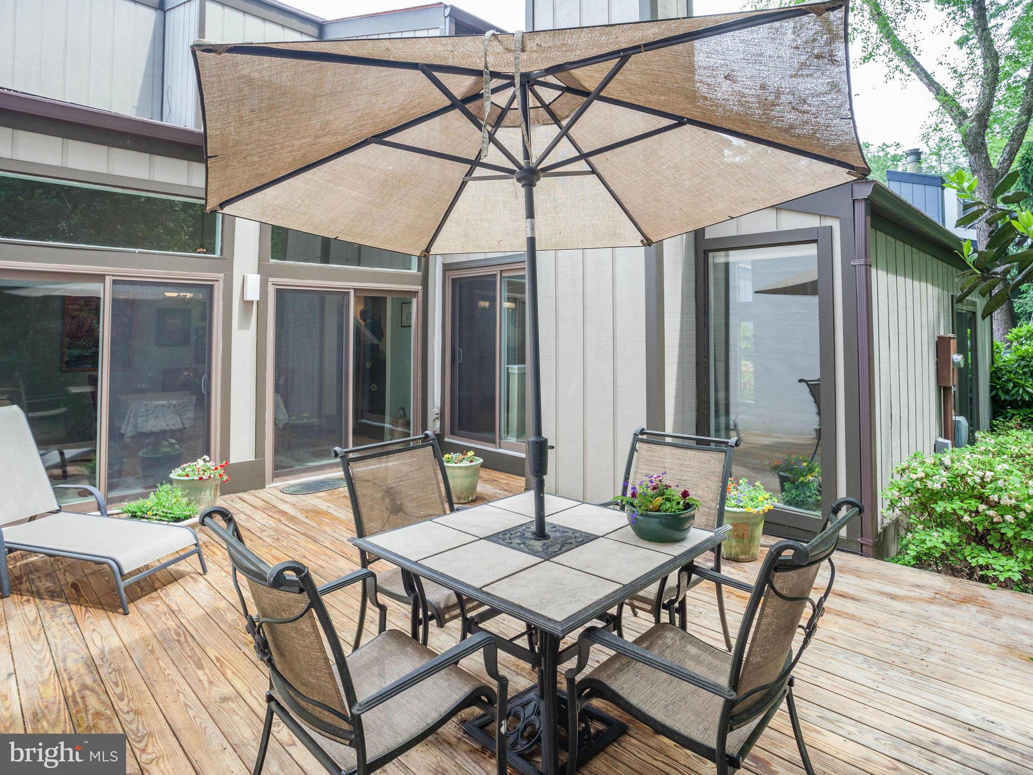 2357 Glade Bank Way Reston, VA 20191 - Photo 26 of 30 a view of a patio with a table and chairs under an umbrella