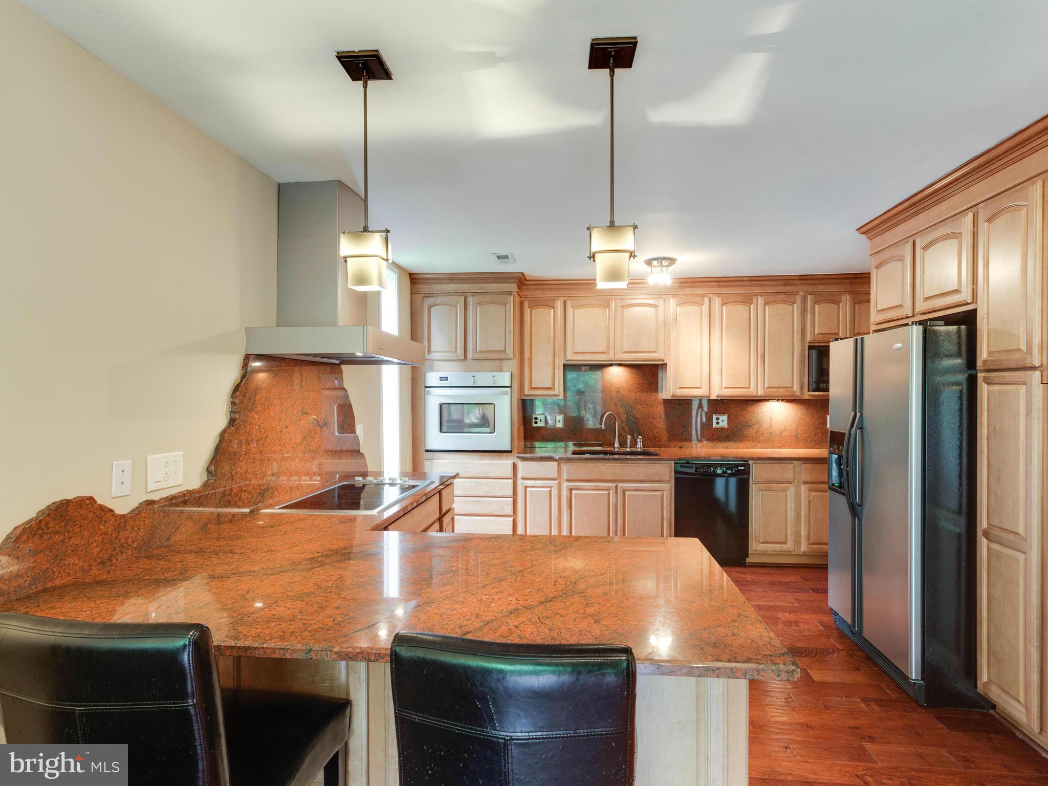 2357 Glade Bank Way Reston, VA 20191 - Photo 4 of 30 a kitchen with stainless steel appliances granite countertop a sink a stove and a refrigerator