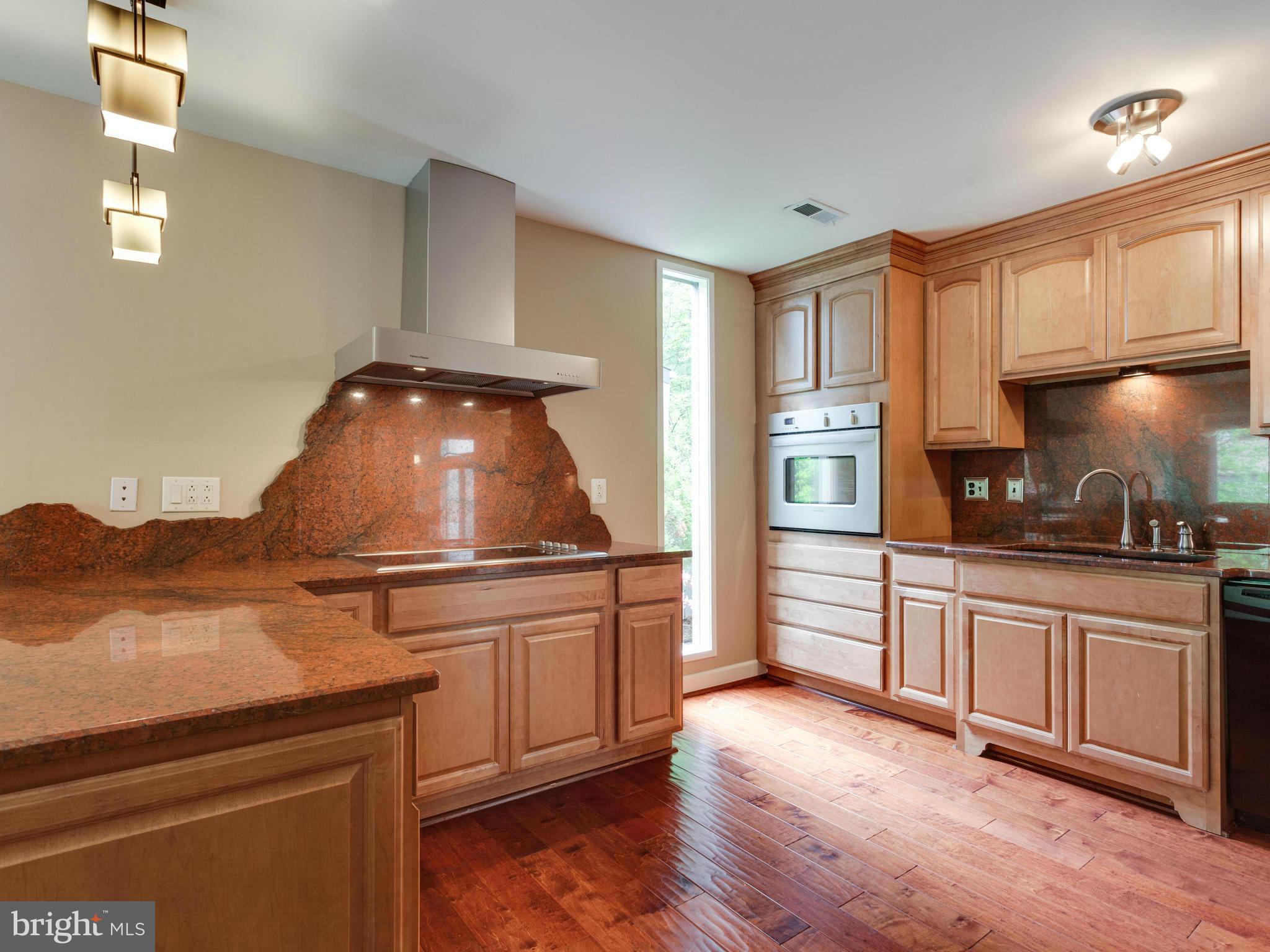 2357 Glade Bank Way Reston, VA 20191 - Photo 7 of 30 a kitchen with granite countertop a stove and a refrigerator