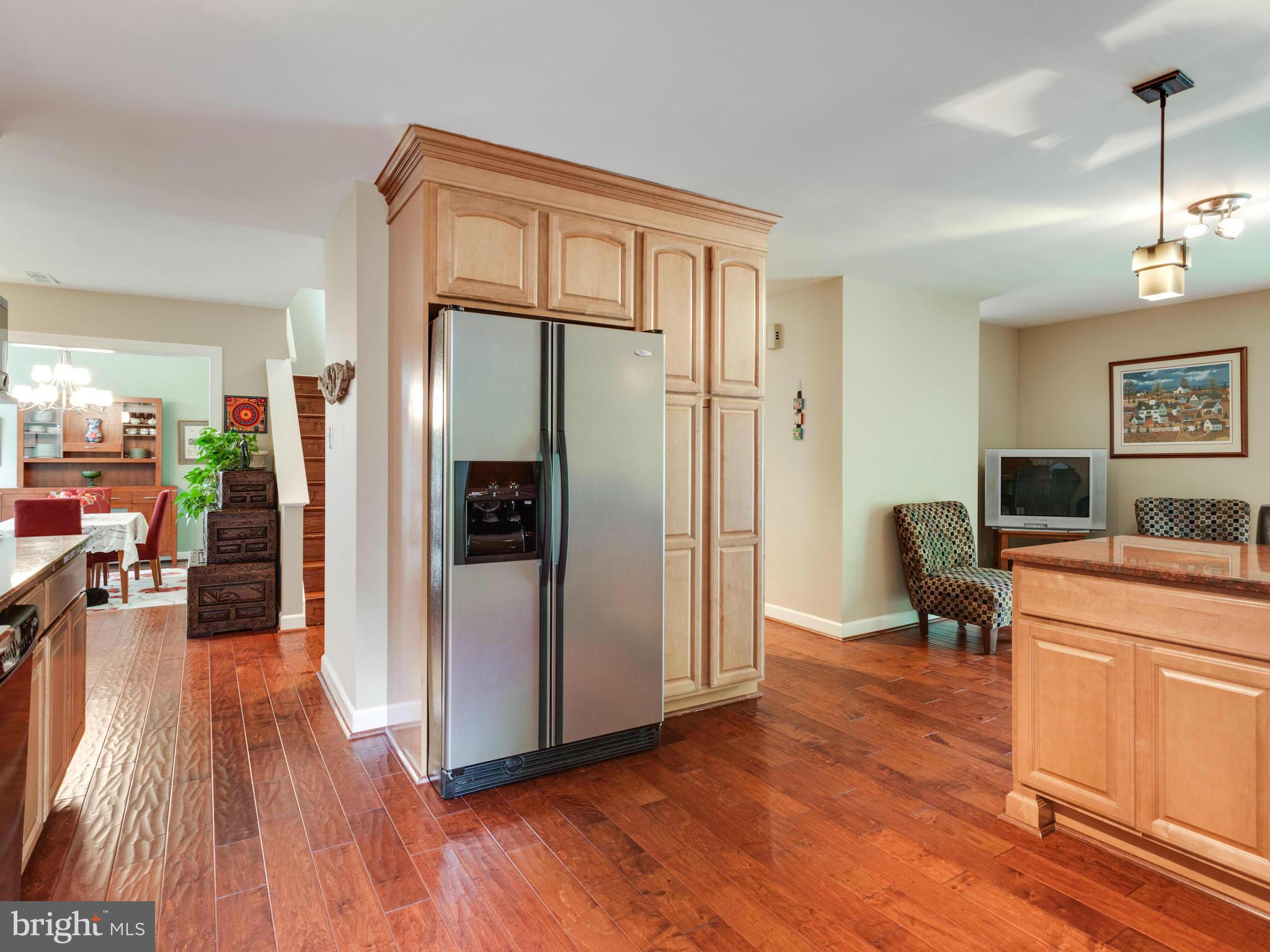 2357 Glade Bank Way Reston, VA 20191 - Photo 8 of 30 a living room with stainless steel appliances furniture refrigerator and a wooden floor