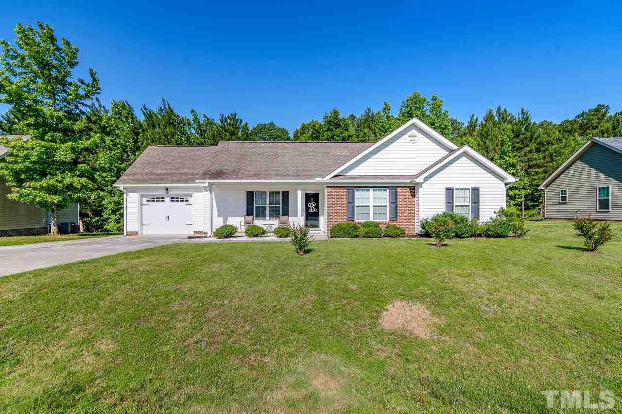 210 Orkney Road Stem, NC 27581 - Photo 1 of 26 a front view of a house with yard and green space