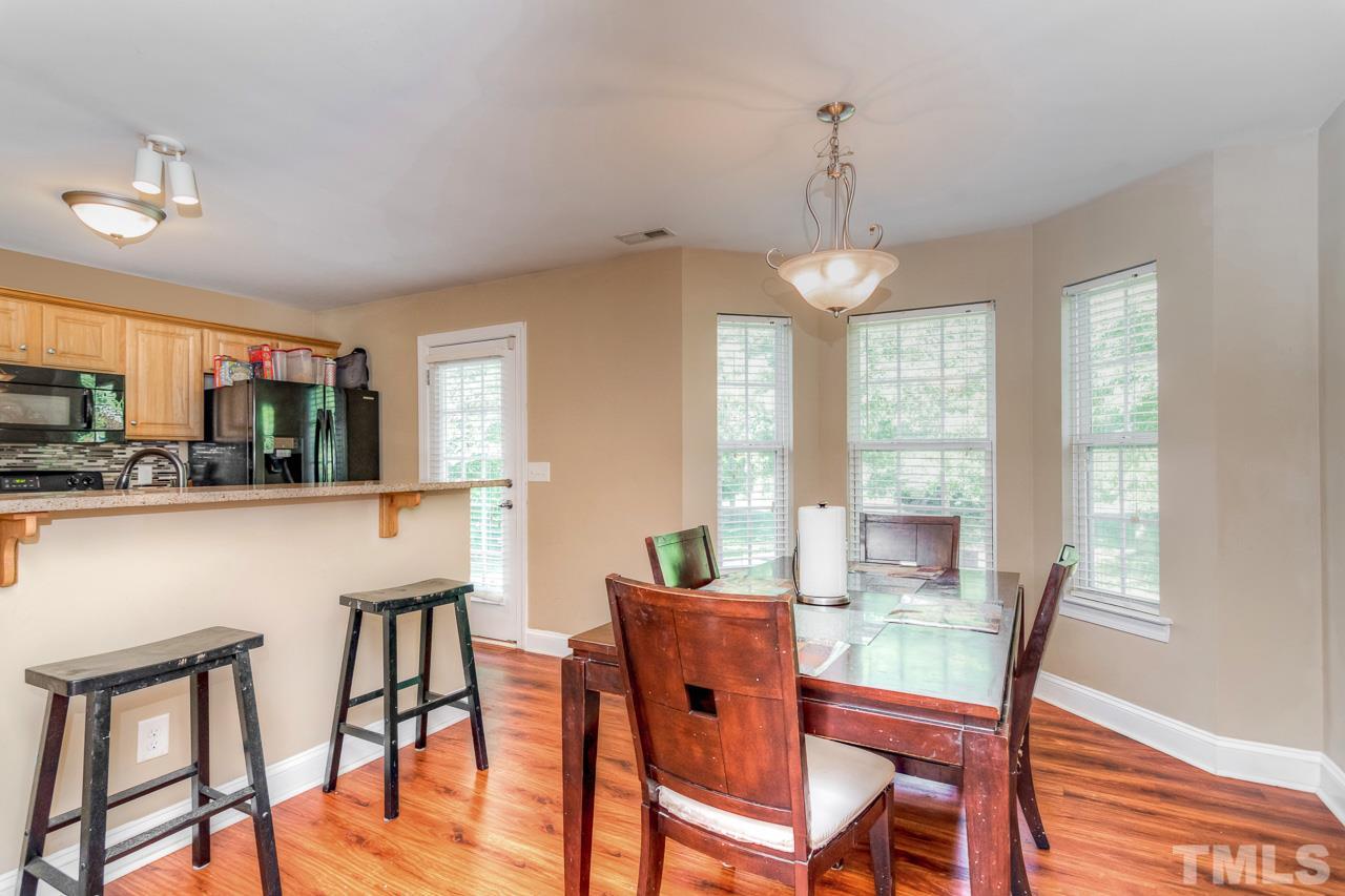 210 Orkney Road Stem, NC 27581 - Photo 12 of 26 a view of a dining room with furniture window and wooden floor