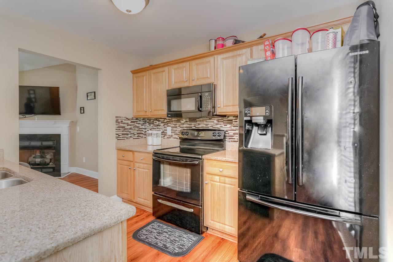 210 Orkney Road Stem, NC 27581 - Photo 14 of 26 a kitchen with granite countertop a refrigerator stove and microwave