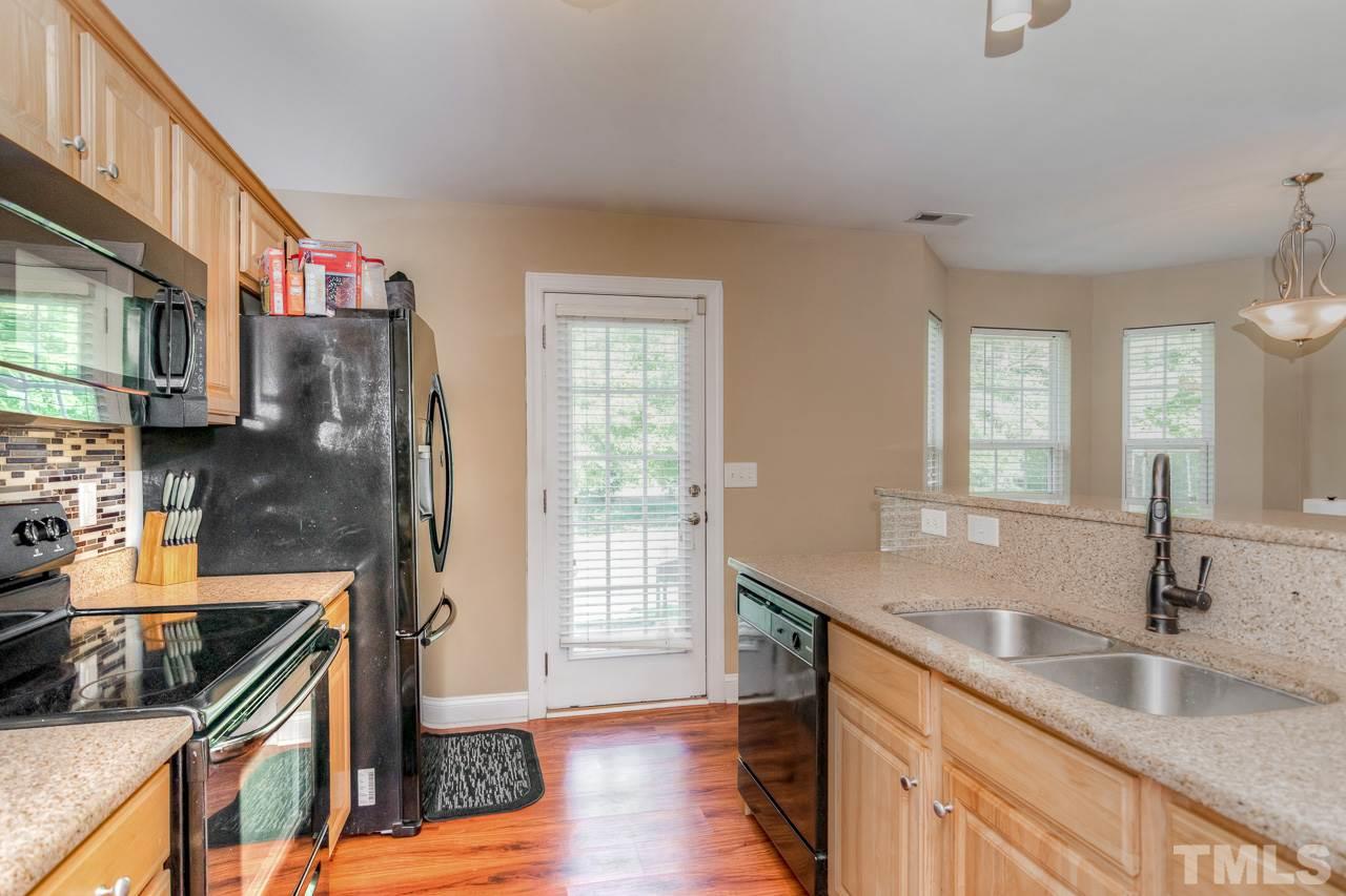 210 Orkney Road Stem, NC 27581 - Photo 15 of 26 a kitchen with stainless steel appliances granite countertop a sink and a stove