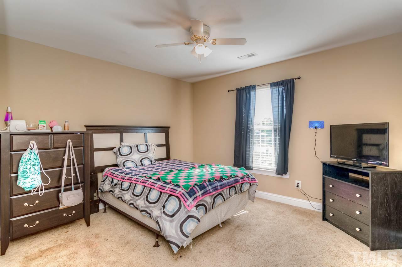 210 Orkney Road Stem, NC 27581 - Photo 16 of 26 a bedroom with a bed and a tv on the dresser