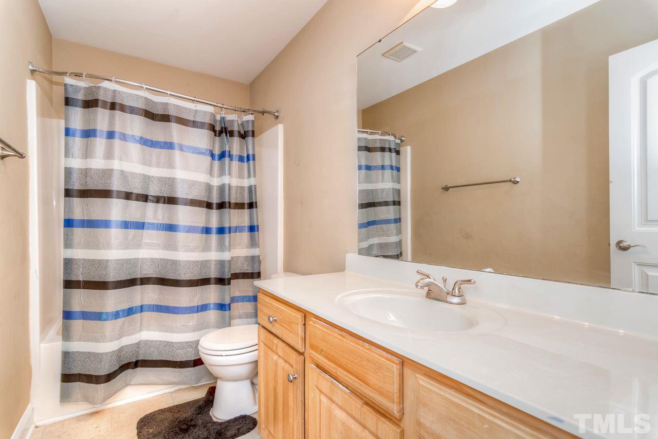 210 Orkney Road Stem, NC 27581 - Photo 20 of 26 a bathroom with a sink toilet and shower