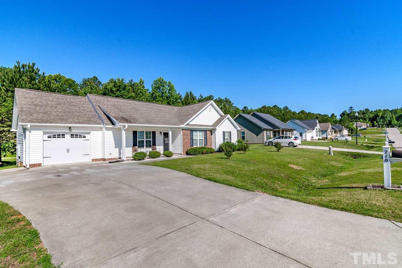 210 Orkney Road Stem, NC 27581 - Photo 3 of 26 a house with green field in front of it