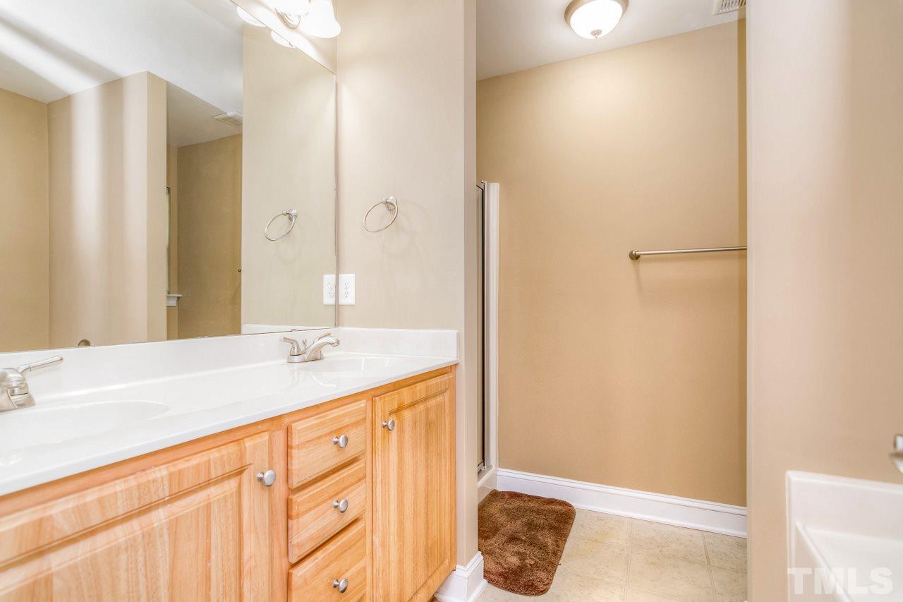 210 Orkney Road Stem, NC 27581 - Photo 24 of 26 a bathroom with a sink and a mirror