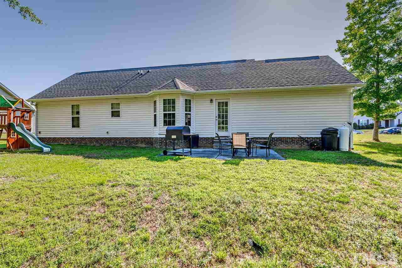 210 Orkney Road Stem, NC 27581 - Photo 6 of 26 a view of a house with table and chairs in patio