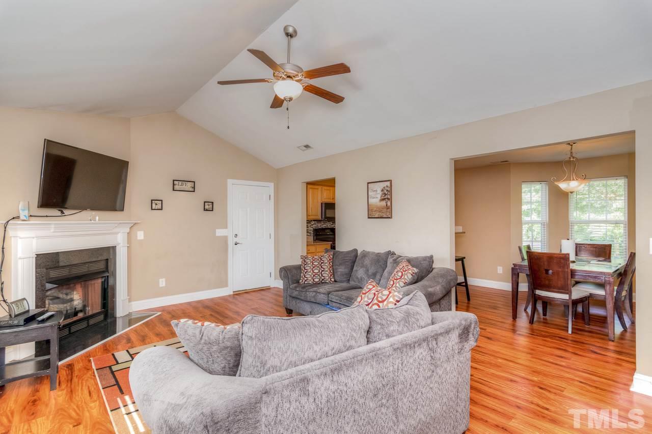 210 Orkney Road Stem, NC 27581 - Photo 8 of 26 a living room with furniture a fireplace and a flat screen tv