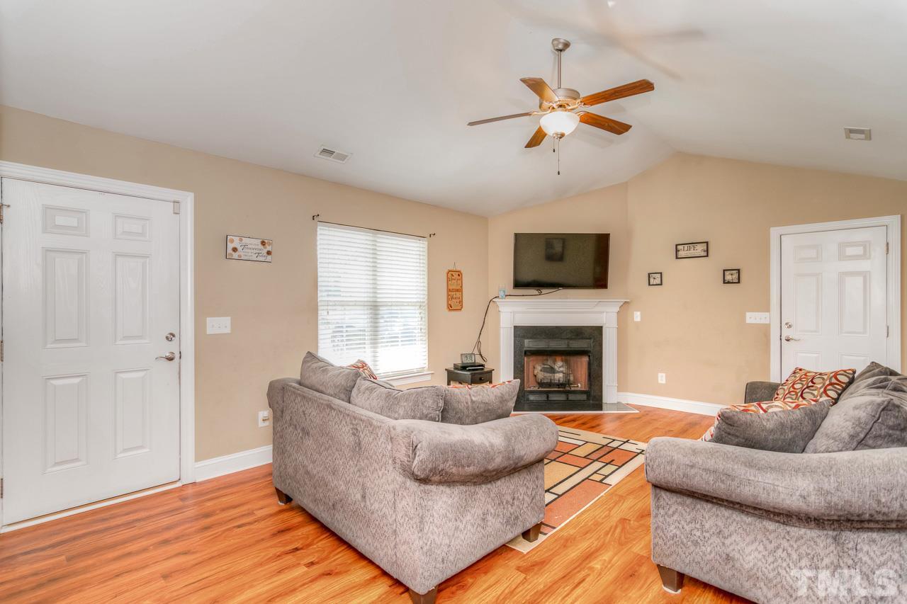 210 Orkney Road Stem, NC 27581 - Photo 10 of 26 a living room with furniture fireplace and a window
