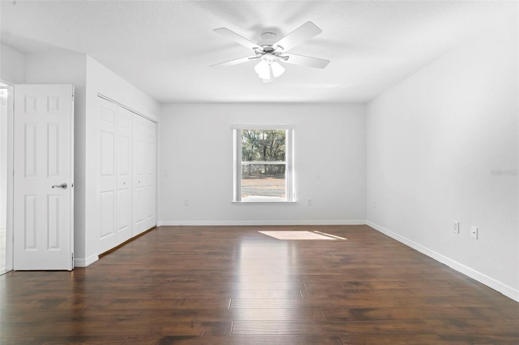 2053 Bond Road DeLand, FL 32720 - Photo 12 of 51 a view of an empty room with wooden floor and a window