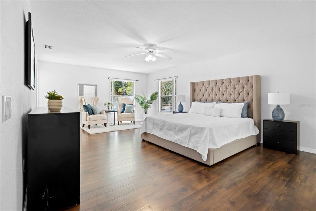 2053 Bond Road DeLand, FL 32720 - Photo 14 of 51 a bedroom with a bed and a chandelier