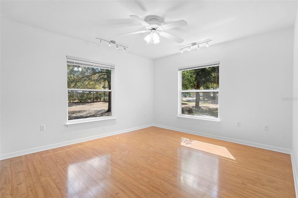 2053 Bond Road DeLand, FL 32720 - Photo 19 of 51 a view of an empty room with a window and a ceiling fan