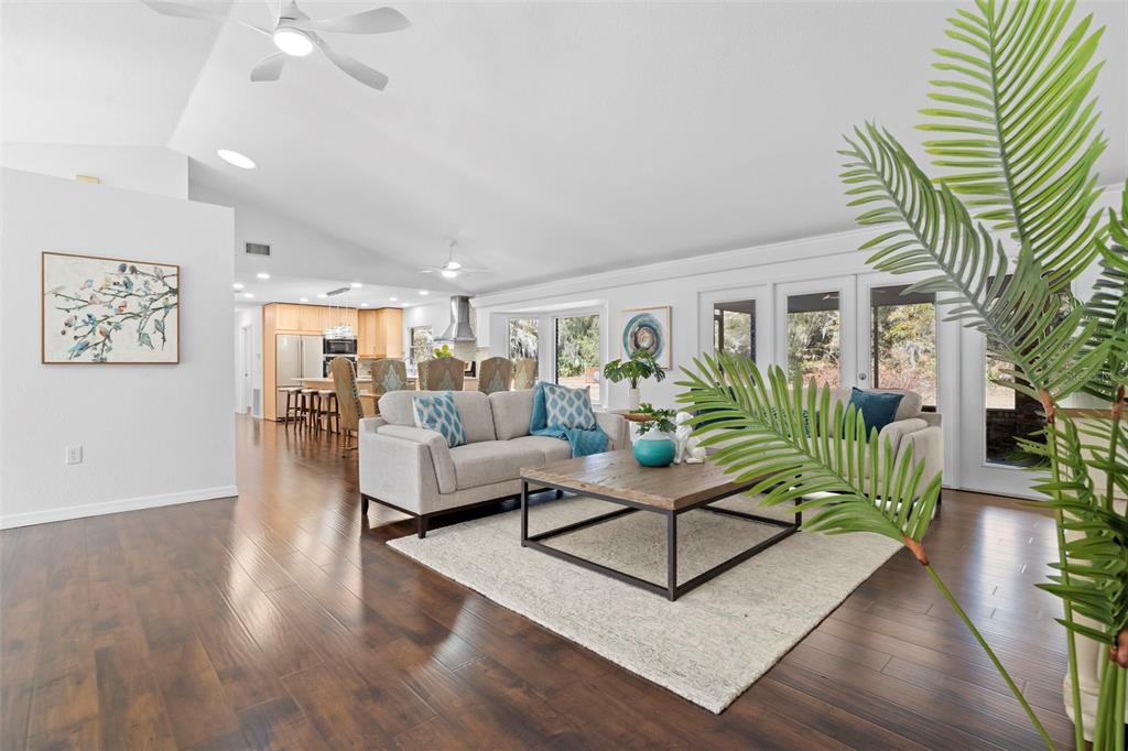 2053 Bond Road DeLand, FL 32720 - Photo 7 of 51 a living room with furniture a wooden floor and a chandelier