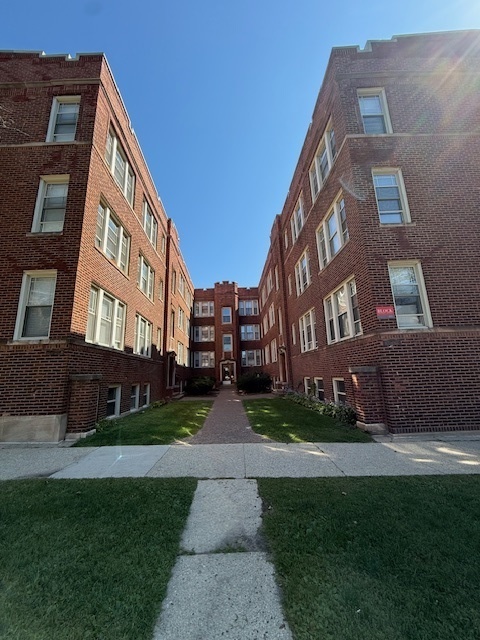 6977 North Bell Avenue, Unit 3 Chicago, IL 60645 - Photo 15 of 15 a view of a brick building next to a yard