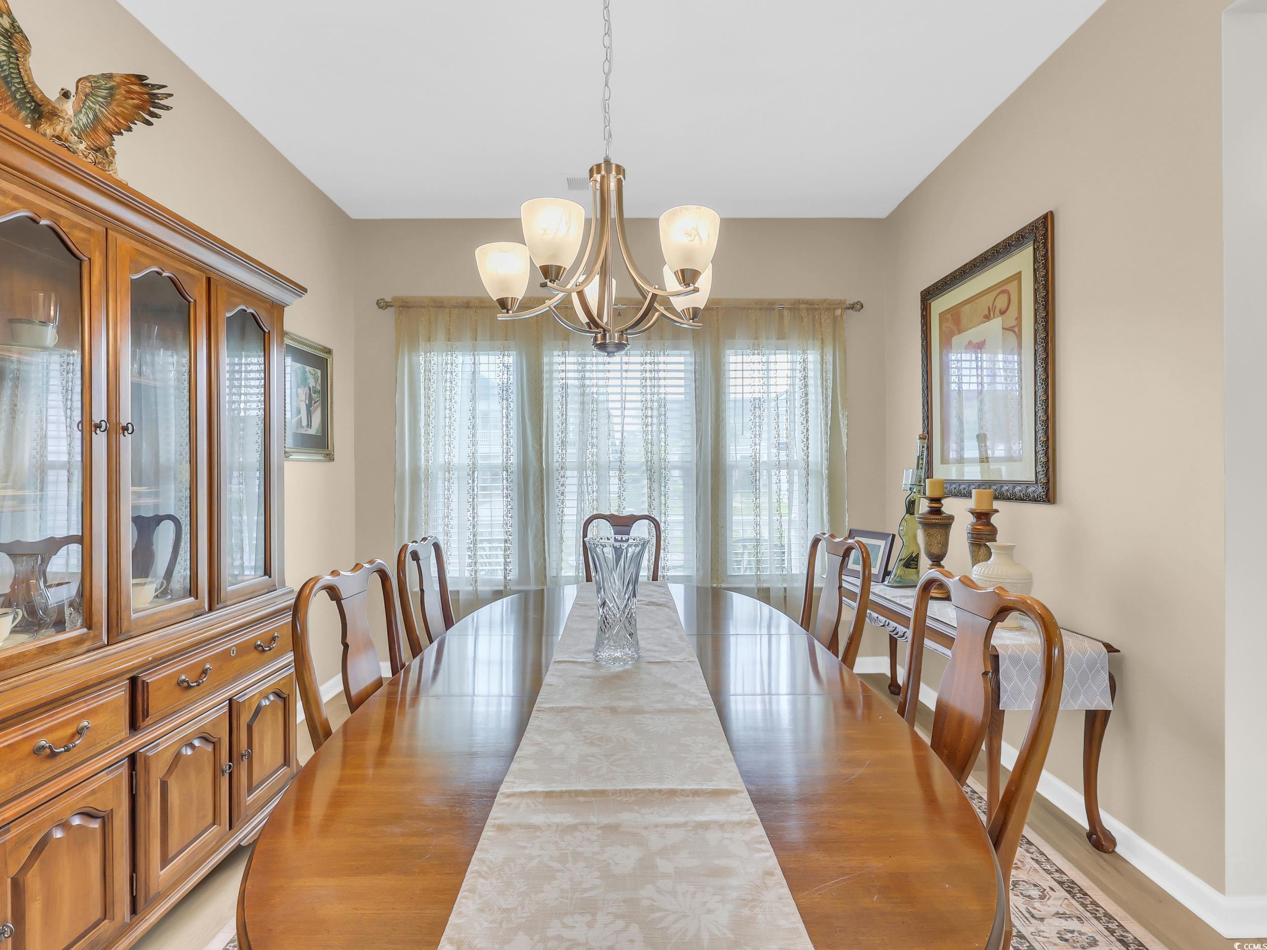 322 Augusta Grn Way Myrtle Beach, SC 29579 - Photo 17 of 34 Dining area with a chandelier and light wood-style floors