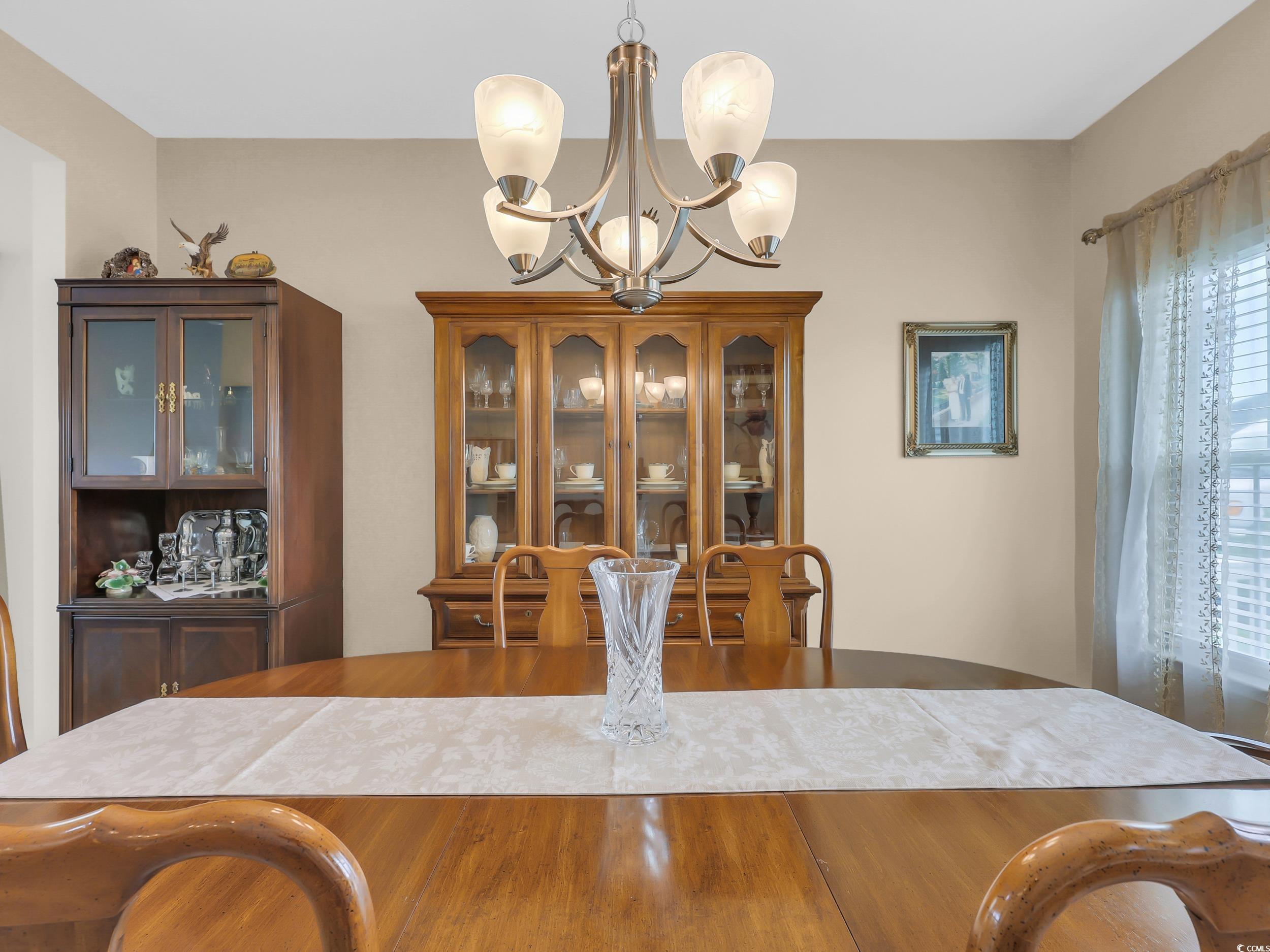 322 Augusta Grn Way Myrtle Beach, SC 29579 - Photo 18 of 34 Dining room with a chandelier