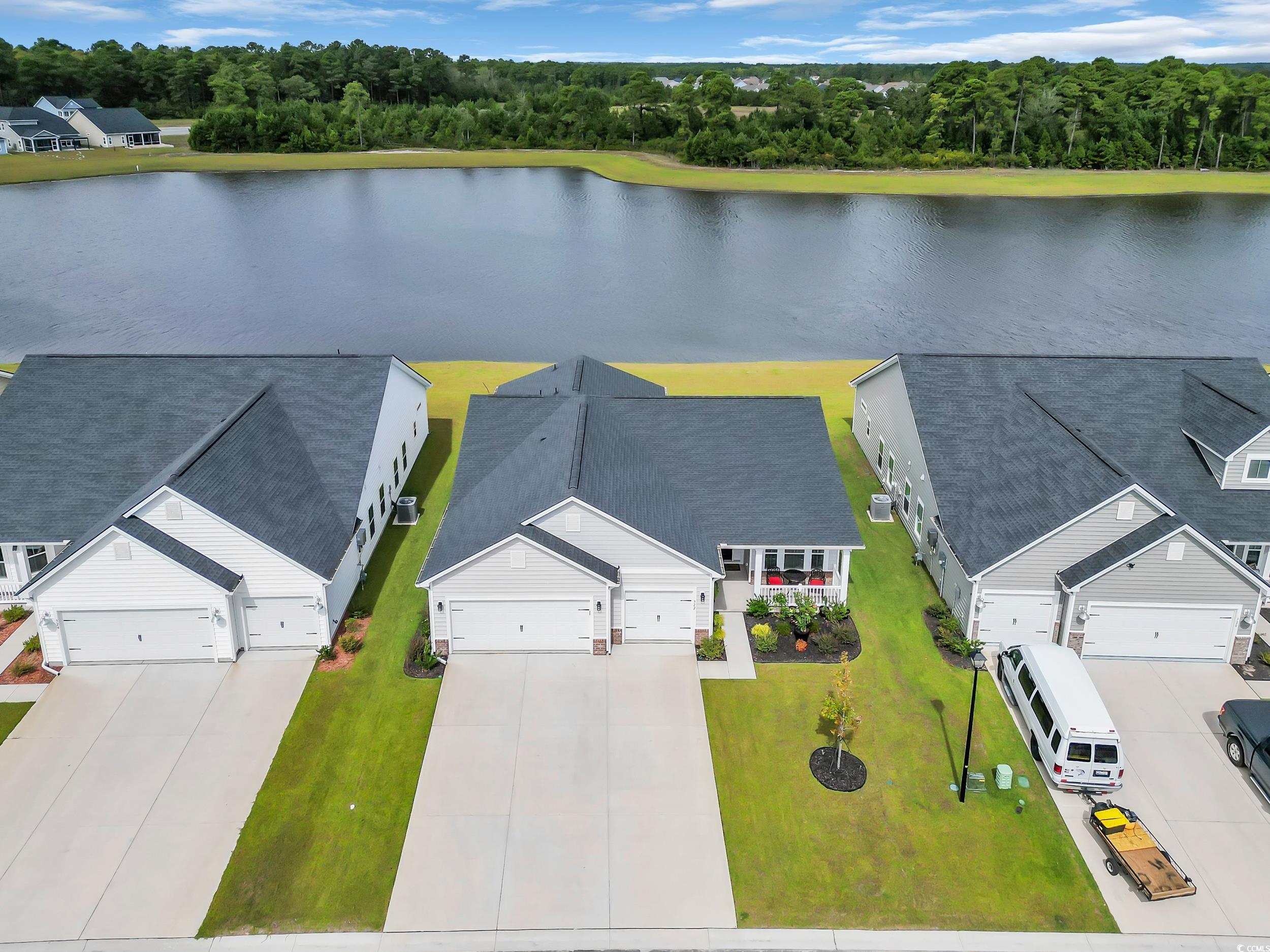 322 Augusta Grn Way Myrtle Beach, SC 29579 - Photo 2 of 34 Drone / aerial view of a large body of water and a tree filled landscape
