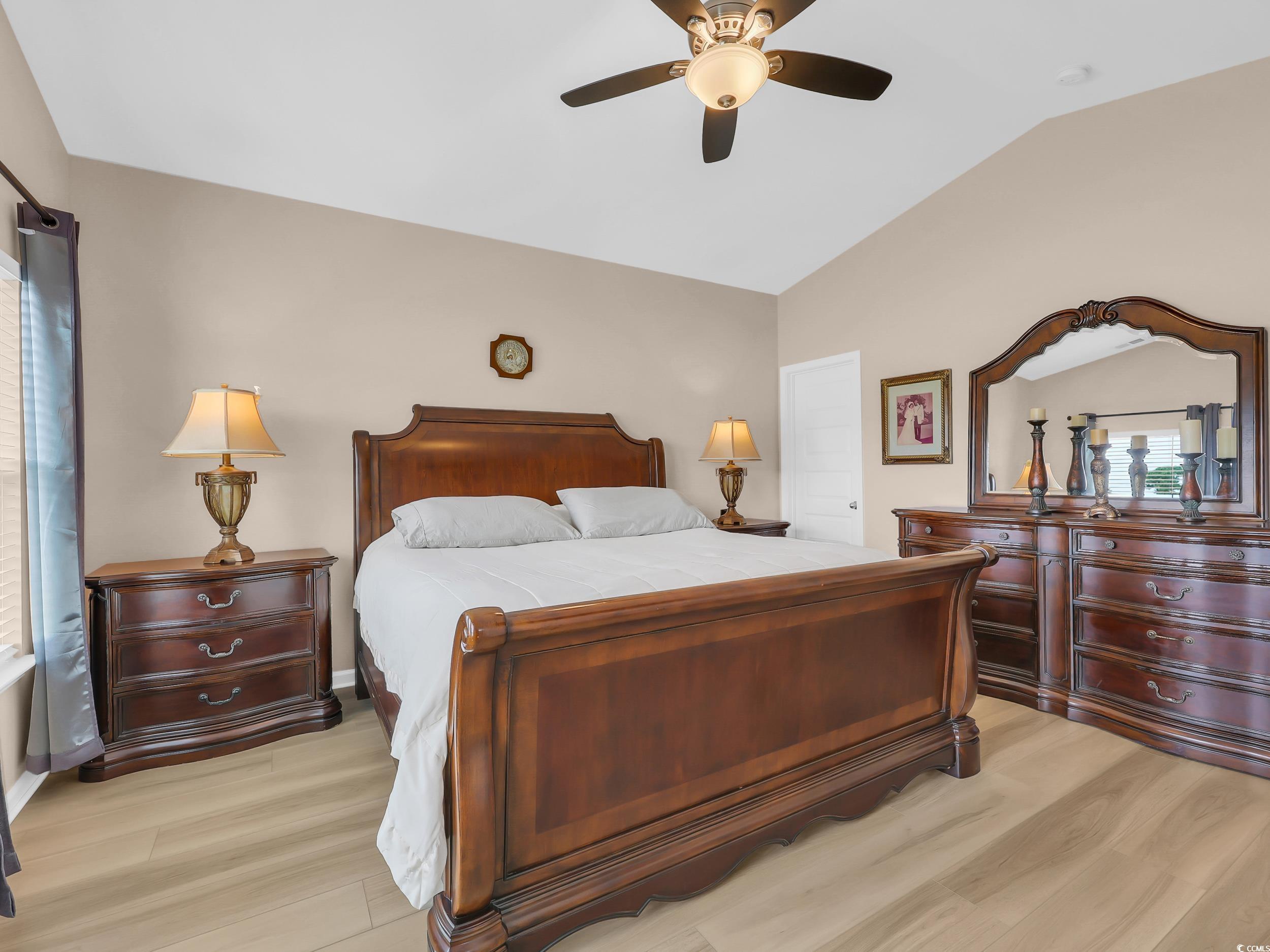 322 Augusta Grn Way Myrtle Beach, SC 29579 - Photo 20 of 34 Bedroom featuring light wood-style flooring, vaulted ceiling, and a ceiling fan
