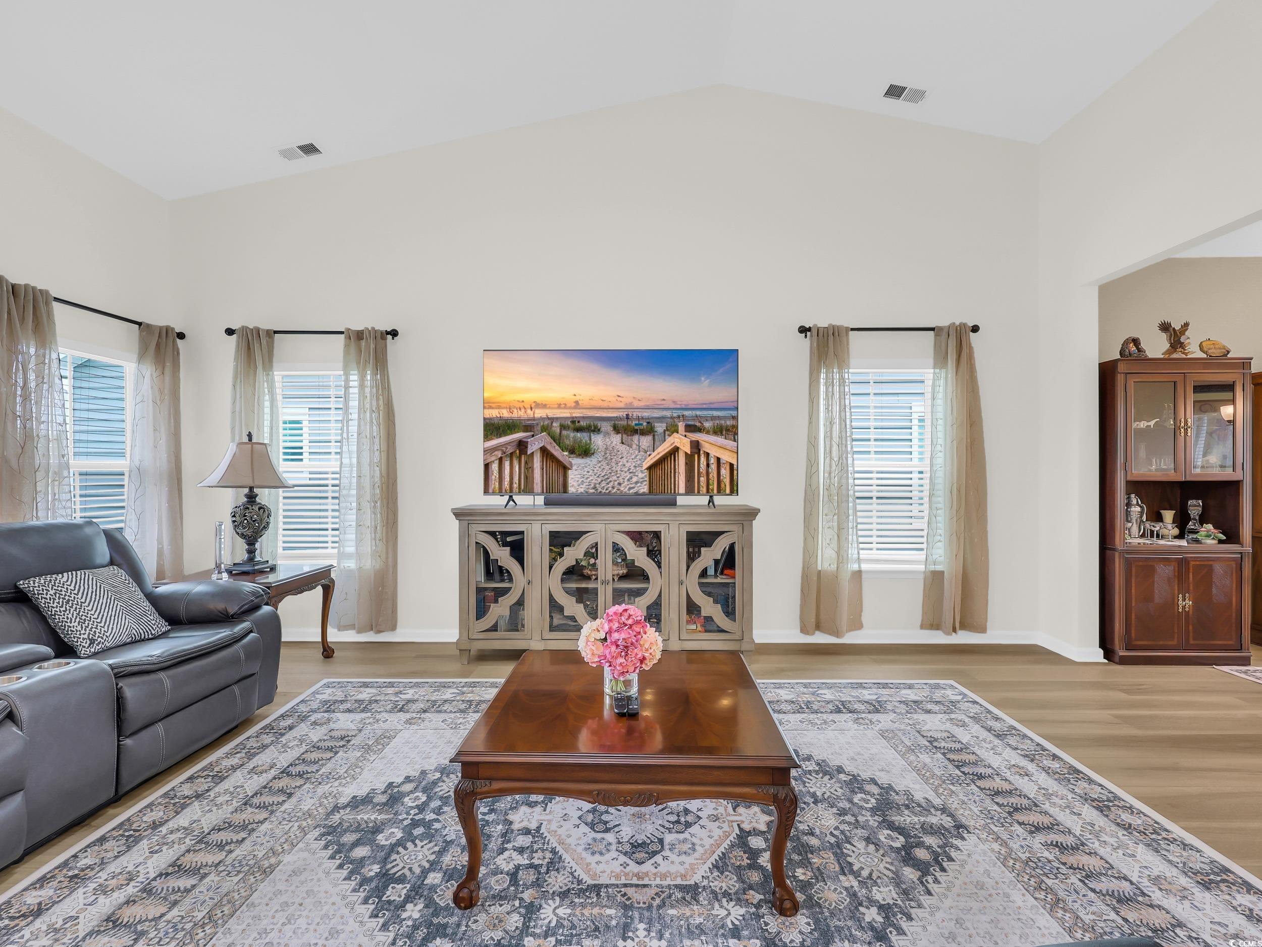 322 Augusta Grn Way Myrtle Beach, SC 29579 - Photo 9 of 34 Living area featuring light wood-style flooring and vaulted ceiling