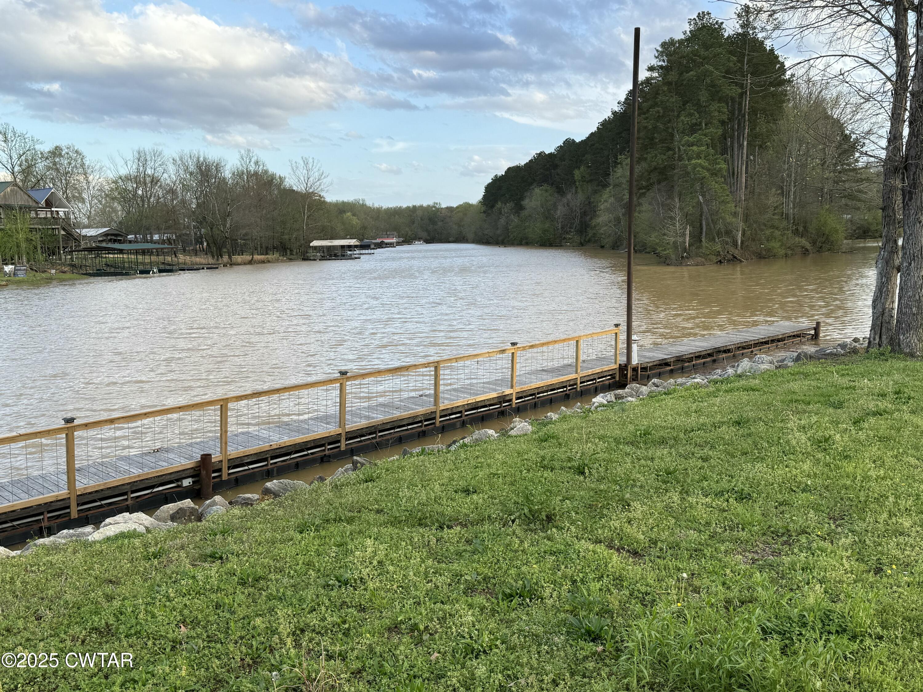 0 Yarbro Harbor Drive Decaturville, TN 38329 - Photo 12 of 16 a view of a lake with a yard and large trees