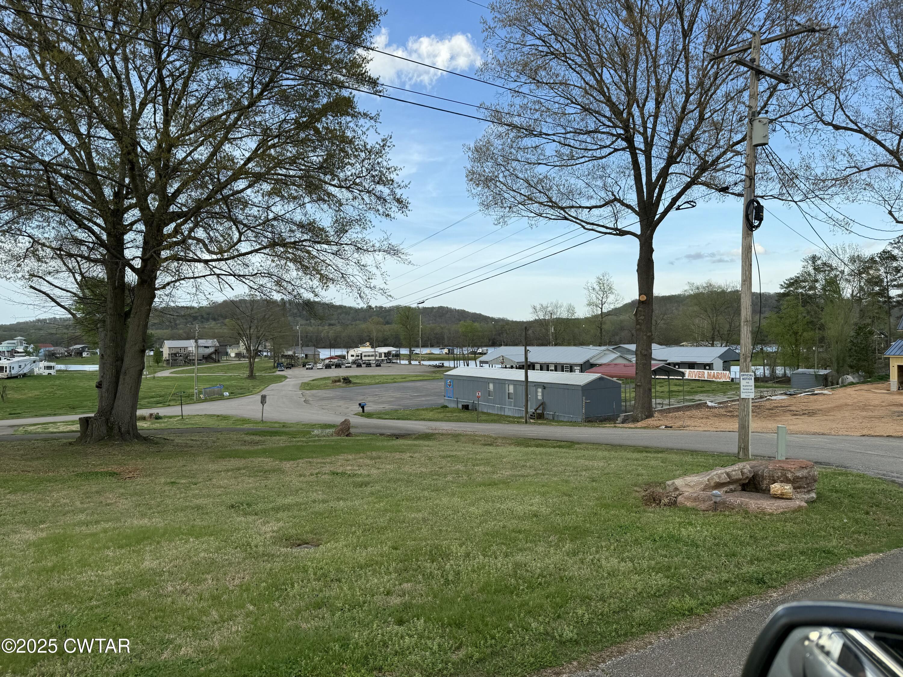 0 Yarbro Harbor Drive Decaturville, TN 38329 - Photo 7 of 16 a view of a swimming pool and trees in the background