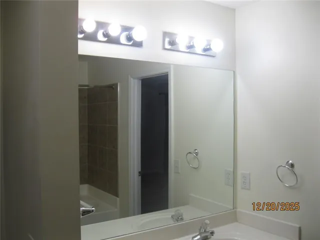a bathroom with a mirror and a shower