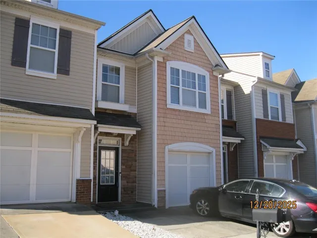 a front view of a house with parking space