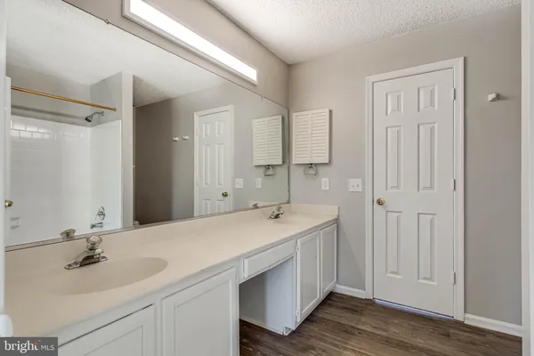 a bathroom with a double vanity sink and mirror