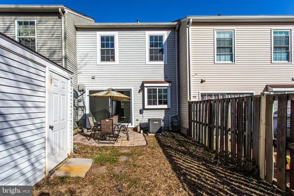 a view of a patio with table and chairs a barbeque with wooden fence