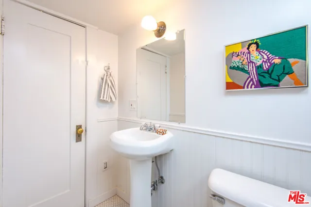 a bathroom with a granite countertop sink a toilet and a shower