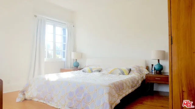 a room with a dresser and a window