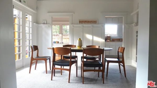 a view of a dining room with furniture and a large window