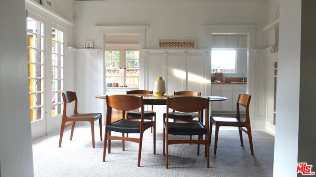 a view of a dining room with furniture and a large window