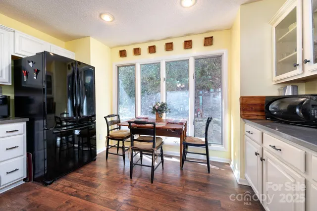 a dining room with furniture and wooden floor