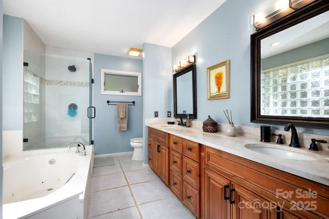 a spacious bathroom with a tub sink and mirror
