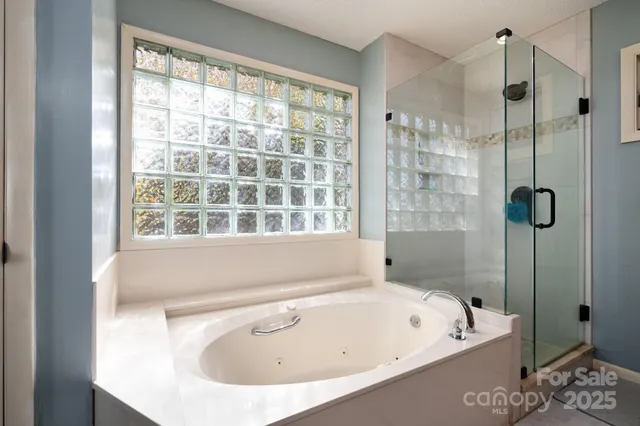 a bathroom with a tub and a window