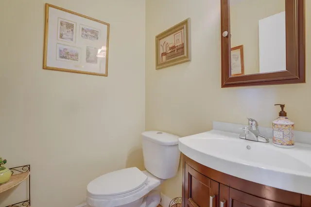 a bathroom with a toilet sink and mirror
