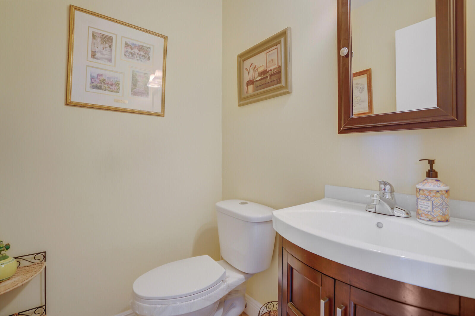 2100 Northeast 38th Street, Unit 111 Lighthouse Point, FL 33064 - Photo 11 of 25 a bathroom with a toilet sink and mirror