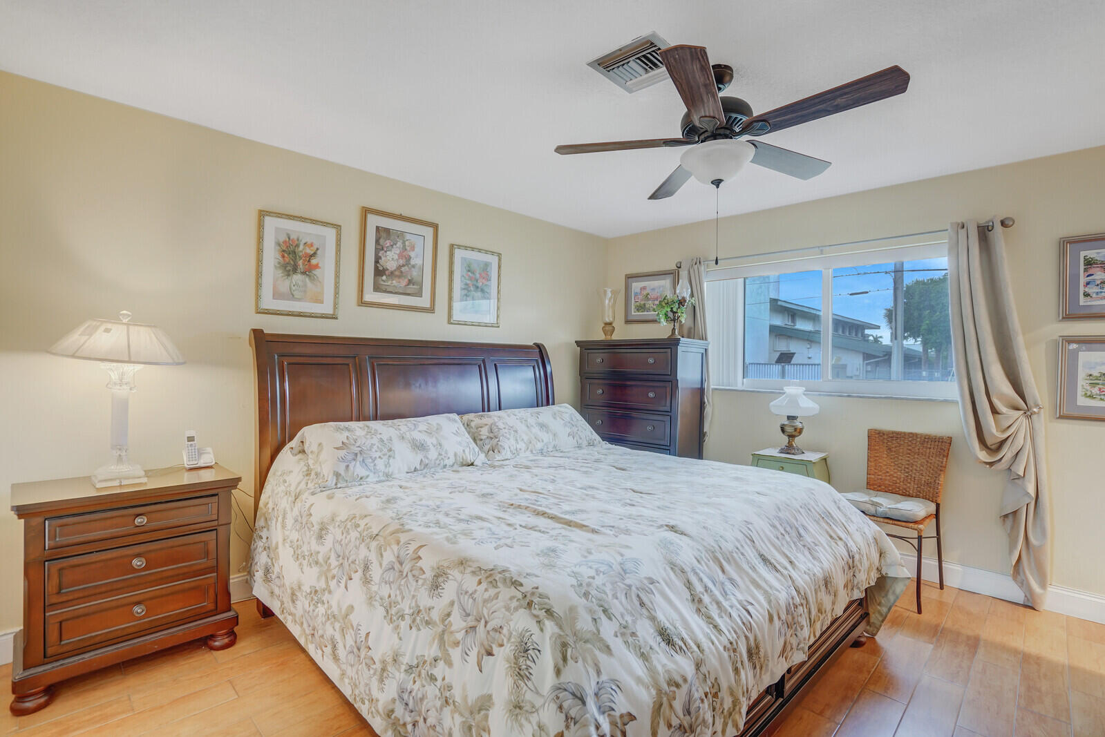 2100 Northeast 38th Street, Unit 111 Lighthouse Point, FL 33064 - Photo 12 of 25 a bedroom with a bed and a chandelier