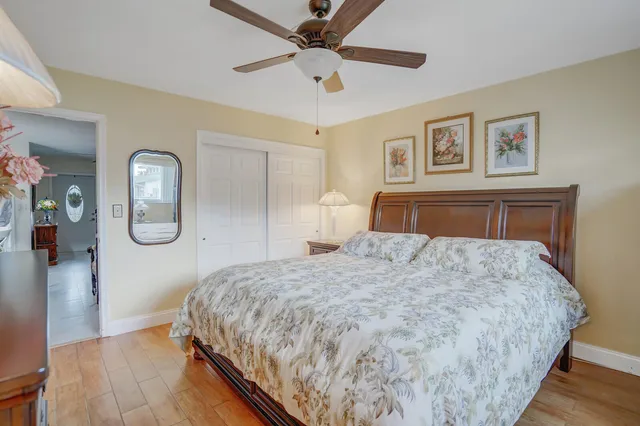 a bedroom with bed and wooden floor