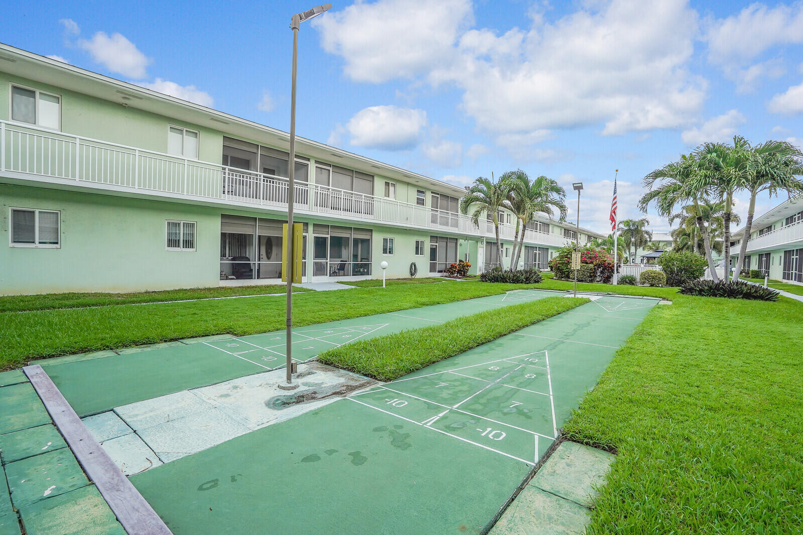 2100 Northeast 38th Street, Unit 111 Lighthouse Point, FL 33064 - Photo 20 of 25 a view of a house with a yard