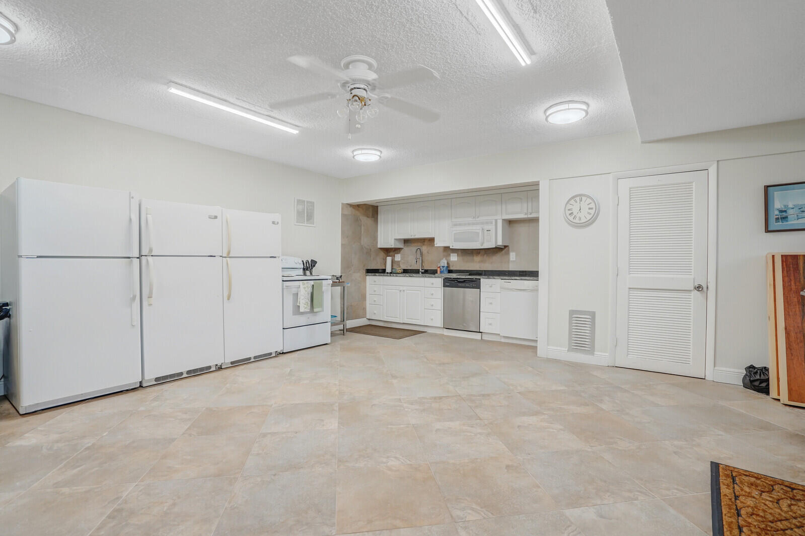 2100 Northeast 38th Street, Unit 111 Lighthouse Point, FL 33064 - Photo 24 of 25 a view of a kitchen with a sink and stainless steel appliances