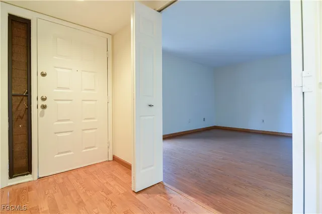 a view of a room with wooden floor and window
