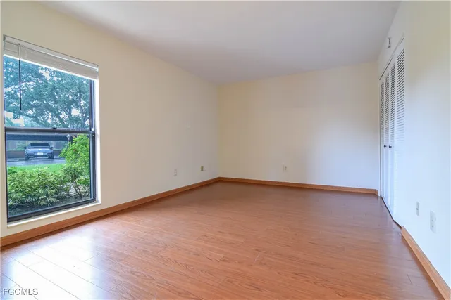 a view of an empty room and wooden floor