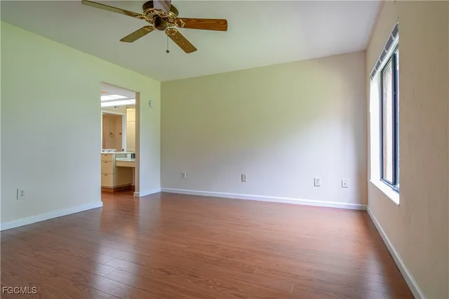 a view of a room with wooden floor and a window