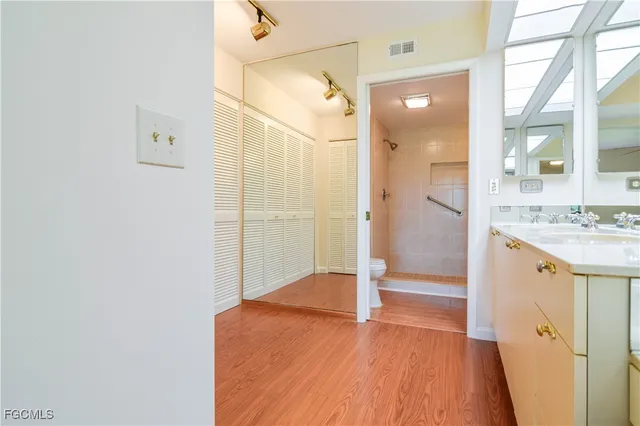 a bathroom with a double vanity sink and a large mirror