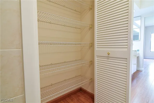 a view of a livingroom with wooden floor and a ceiling fan